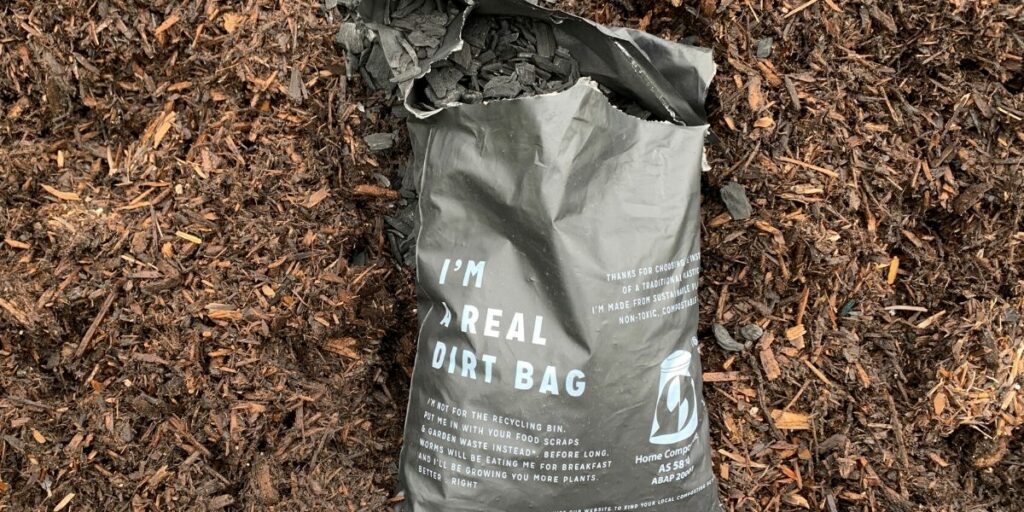 Bag of biochar on top of soil and compost mixture. 