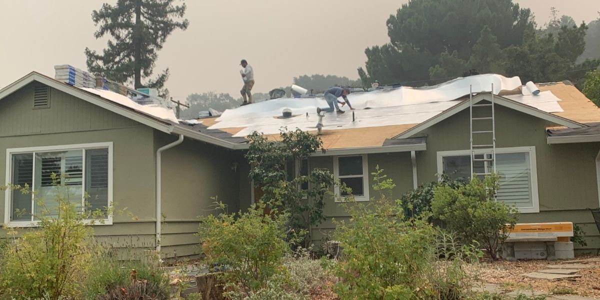 Men installing cool roof