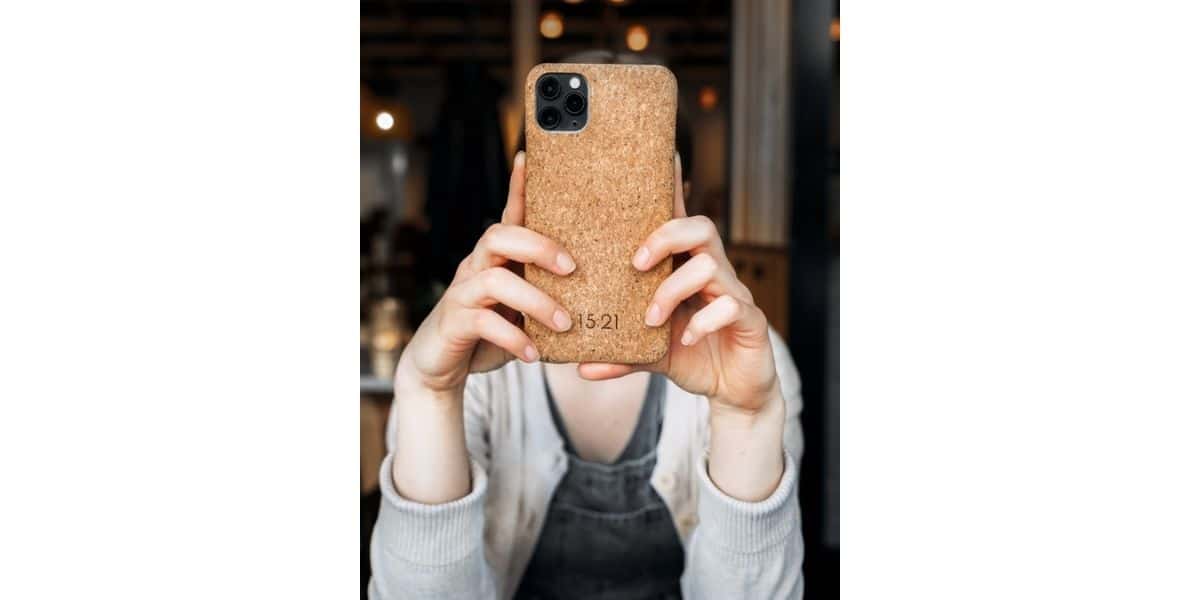 Hands holding phone case made from cork bark