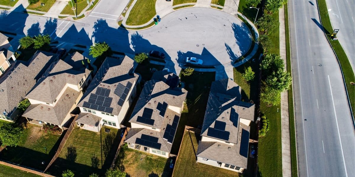 Neighborhood with multiple single family homes with solar panels on the roof