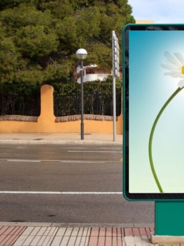 ad with a bee on a flower on a city street